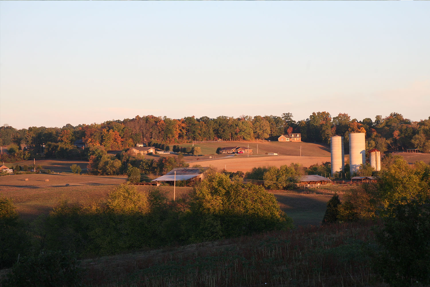Evening view of farmland and silos near the club