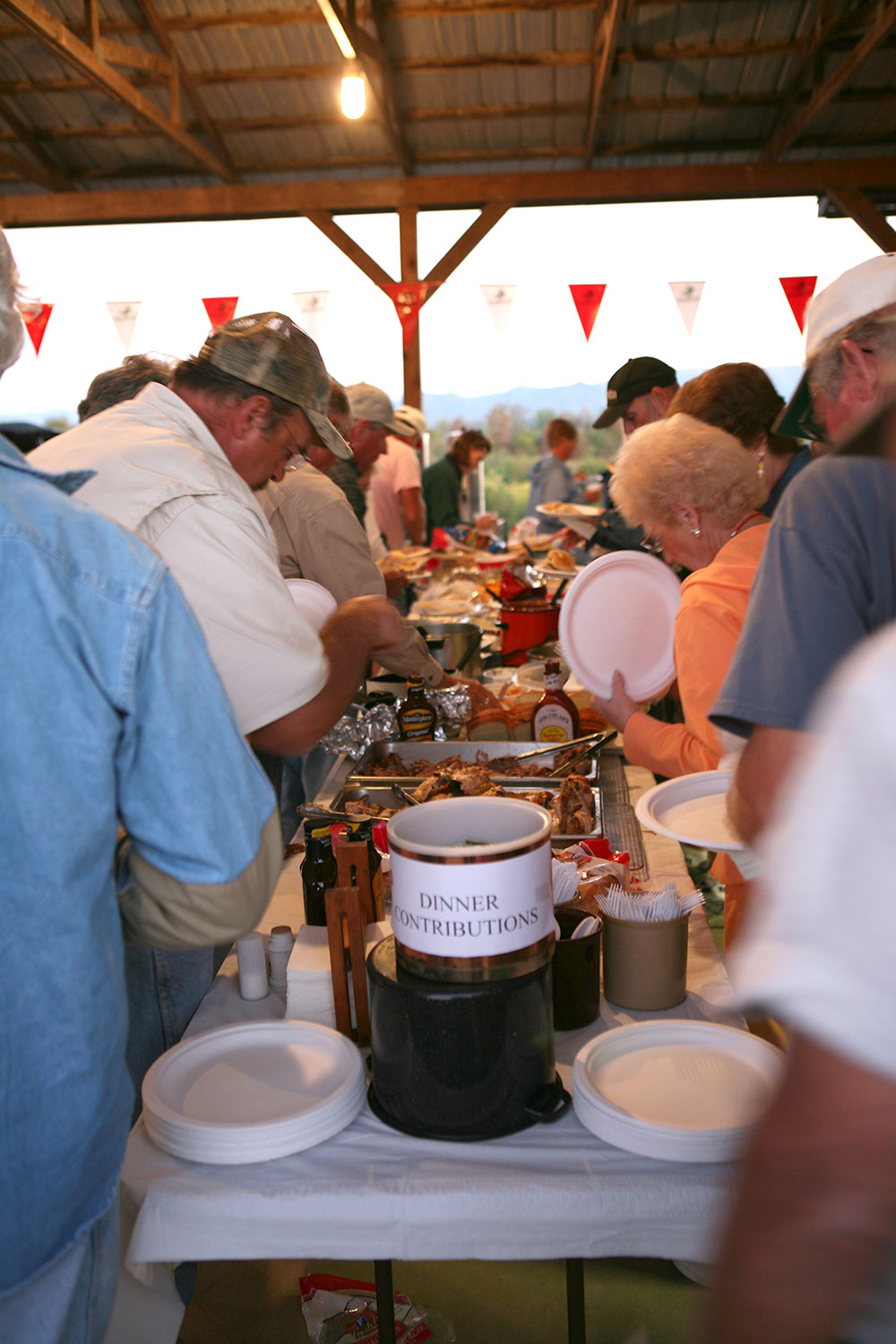 Shooters serving themselves at the potluck table