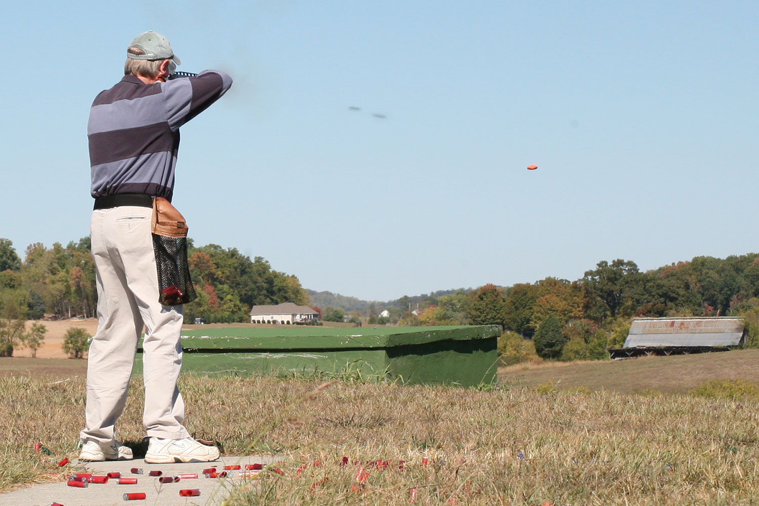 Shooter firing at a clay target