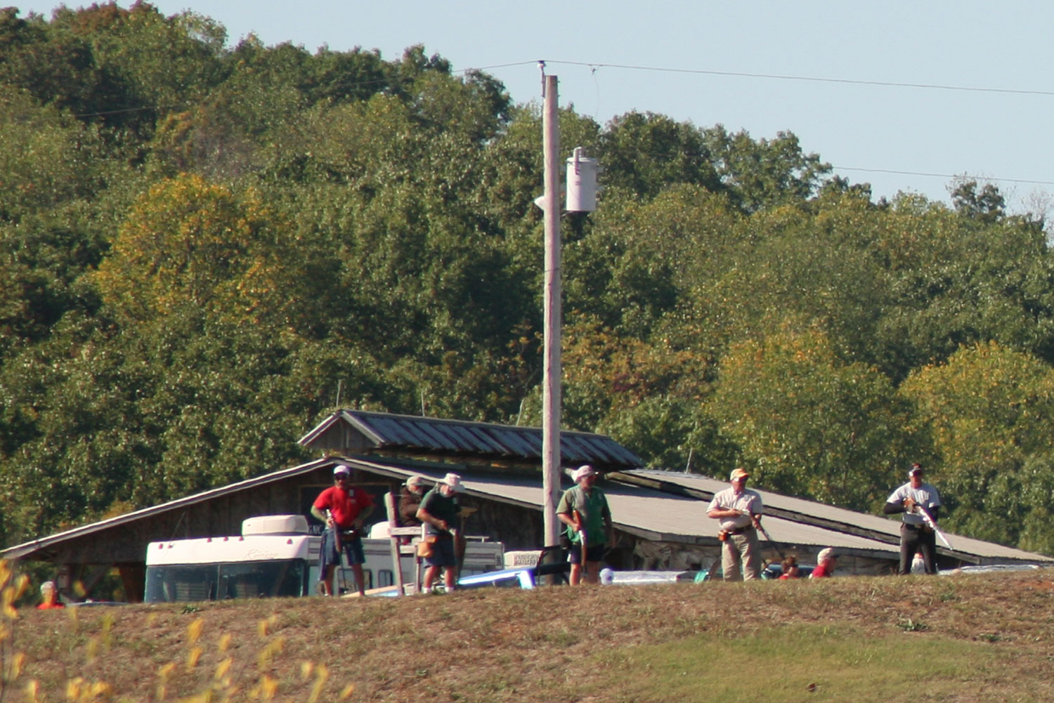 Shooters near a trap house with the pavilion behind
