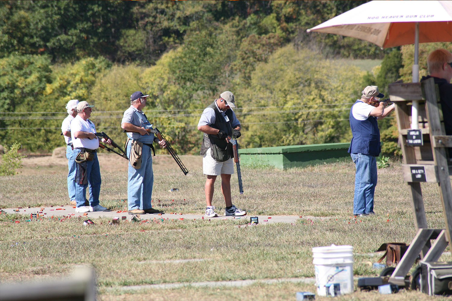Squad shooting beside an orange scorer's umbrella